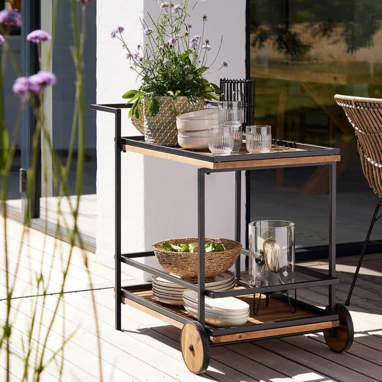 Mediterranean patio area with dining table and bush