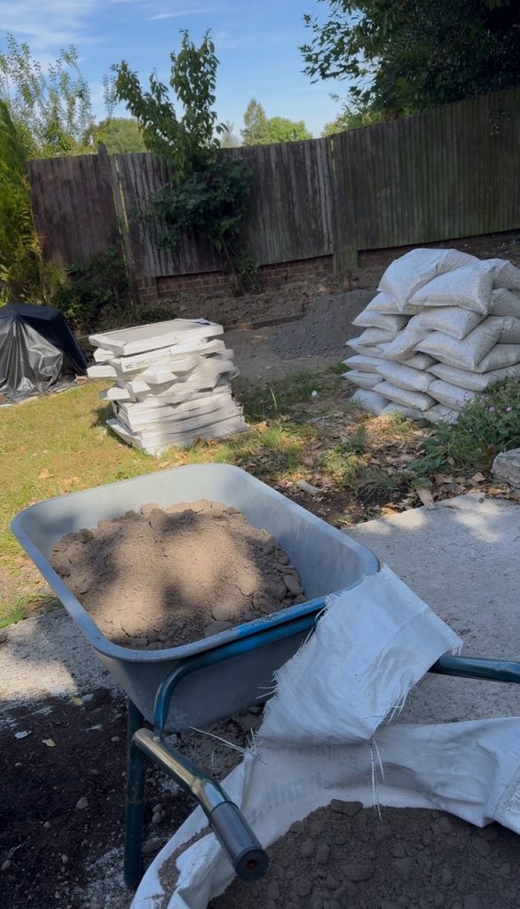 wheelbarrow and bulk bag for DIY porcelain patio