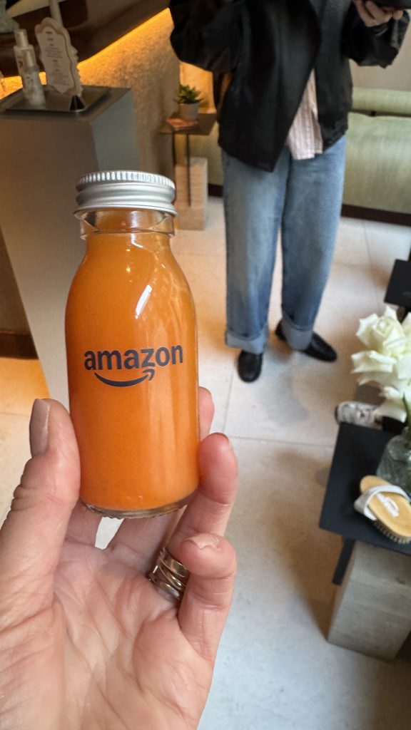 Hand holding Amazon-branded juice bottle.