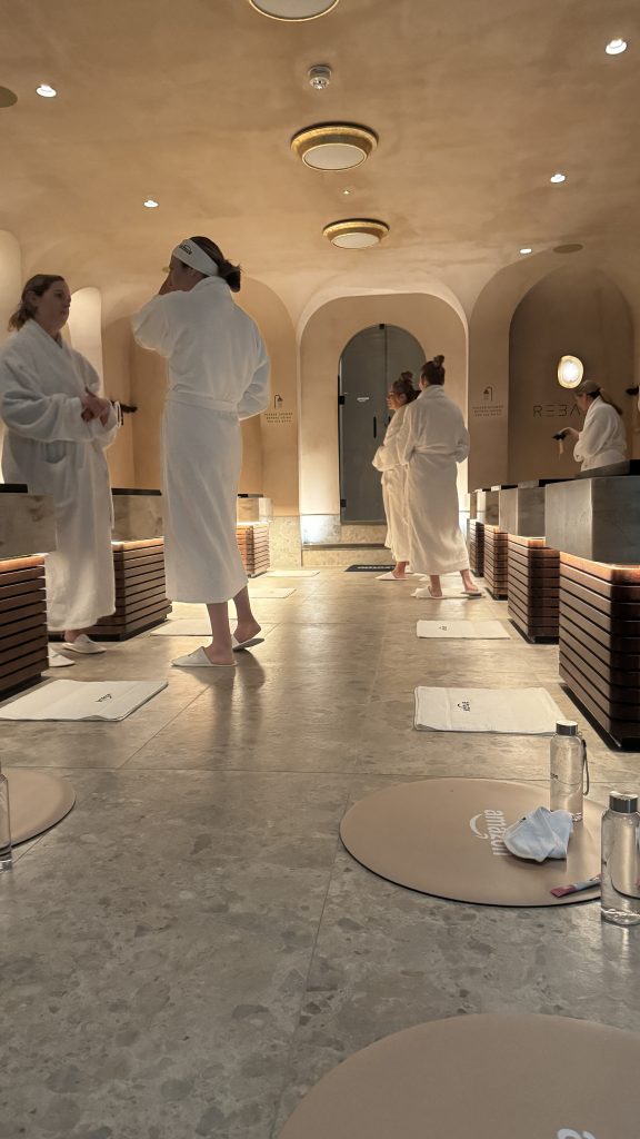 Spa interior with people in robes at Rebase recovery.