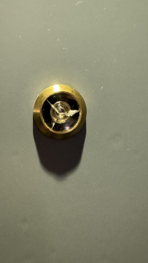 cracked peep hole in room door