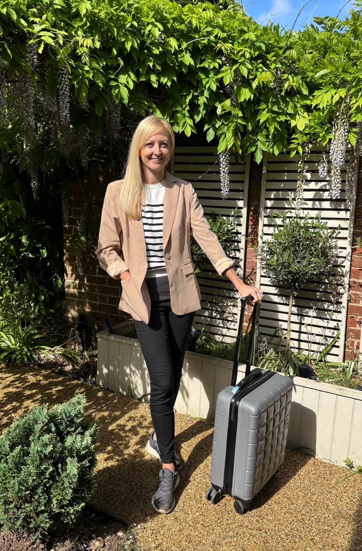 Claire douglas with suitcase full of top amazon travel finds