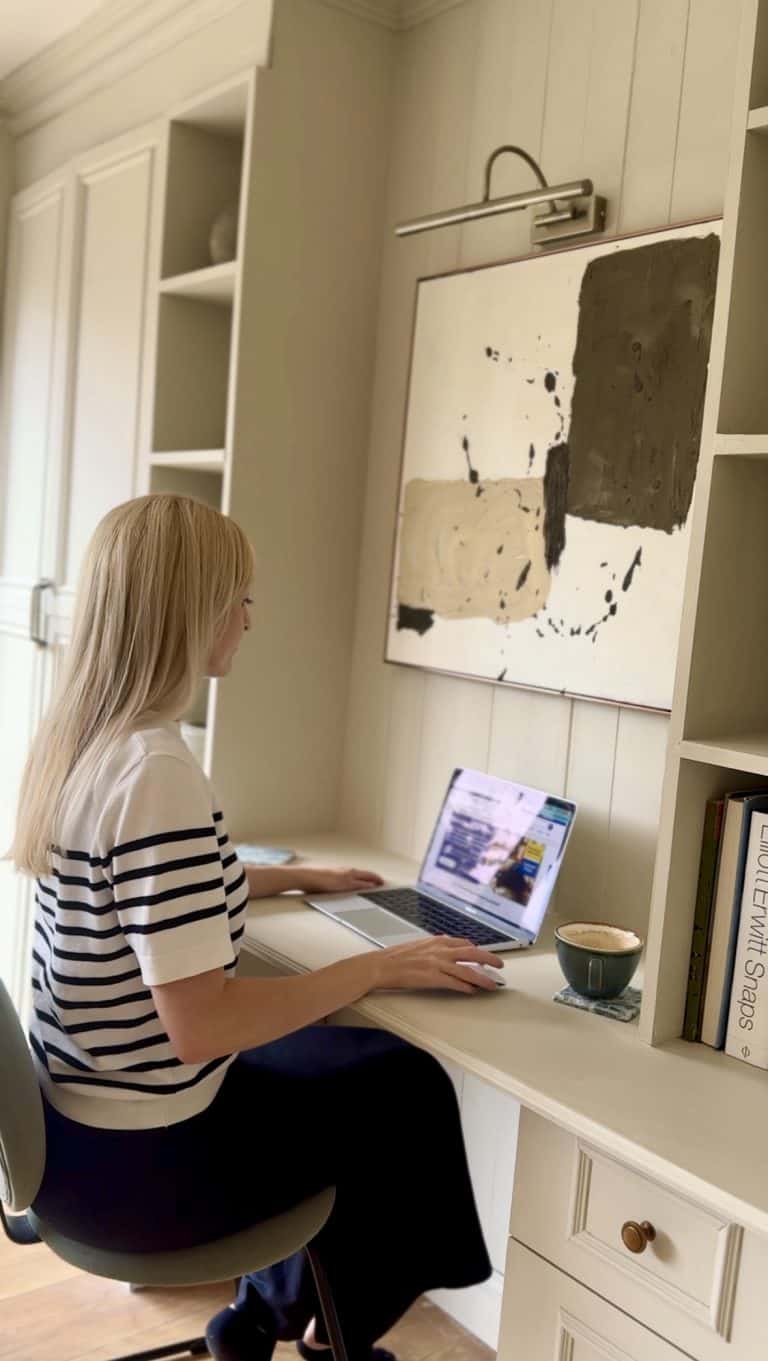 Claire Douglas sat at desk on laptop searching for best amazon finds on a budget